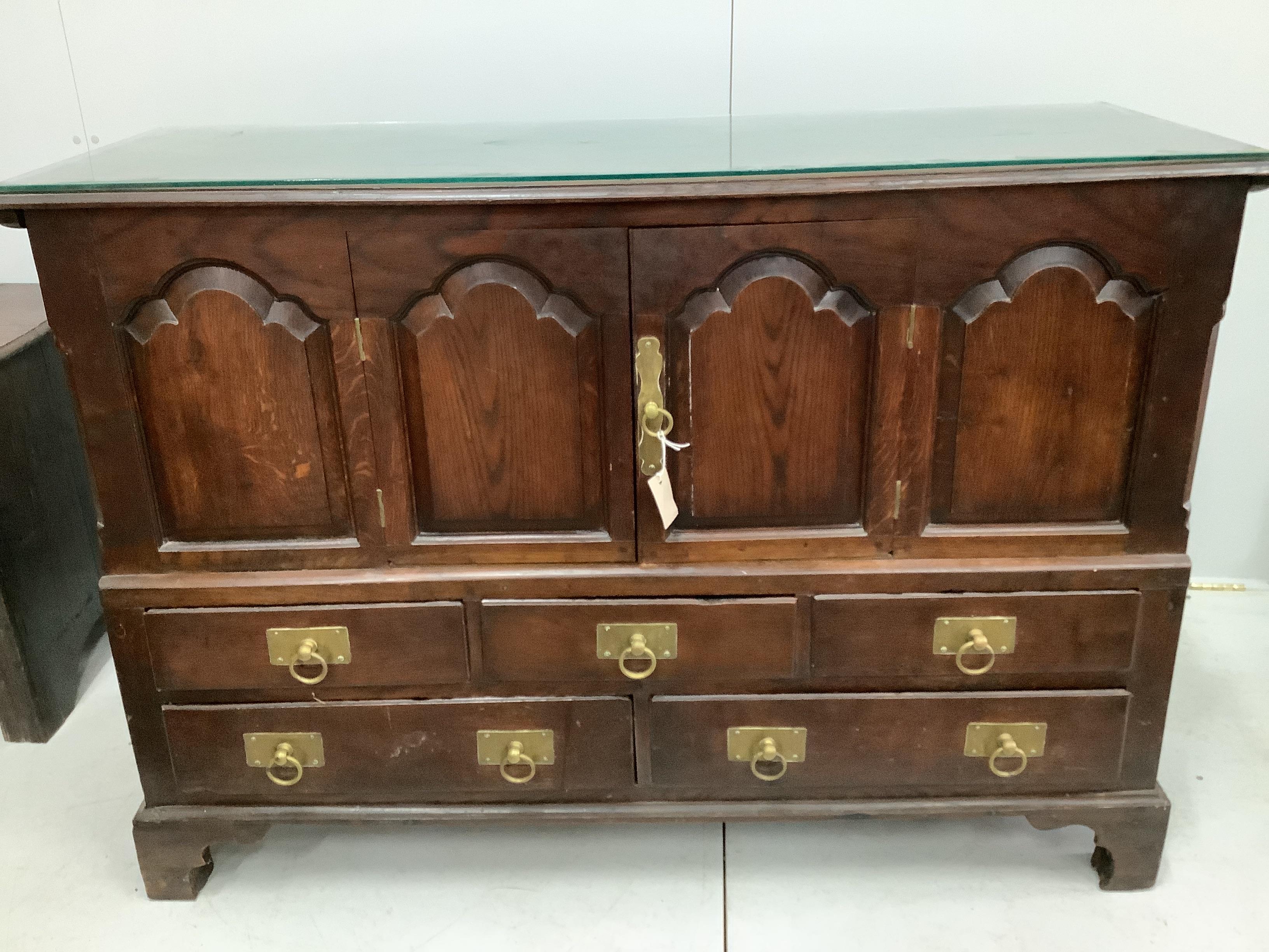 An 18th century panelled oak mule chest, (adapted), width 146cm, depth 54cm, height 100cm